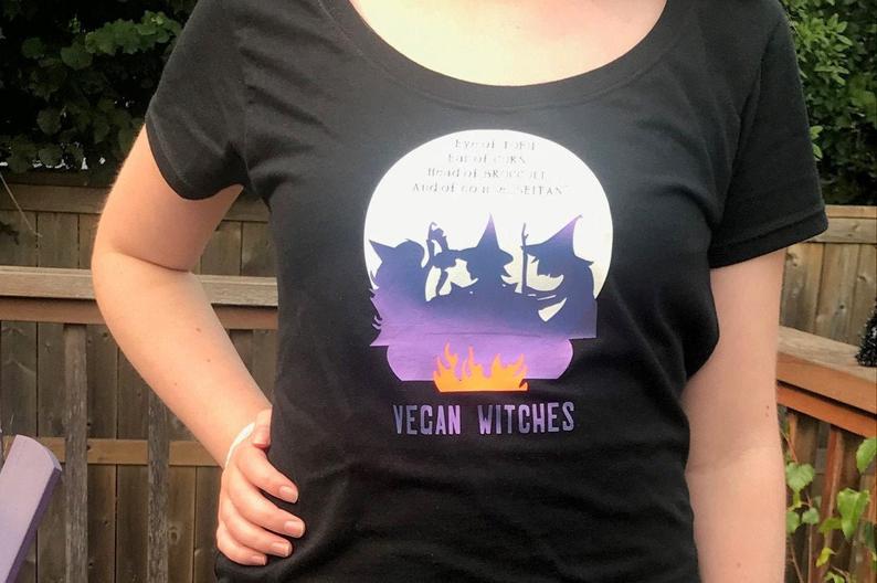 vegan witches with cauldron halloween tee ladies t-shirt black with purple blue metallic boat neck cotton tee