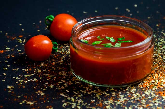 salsa ketchup with small tomatoes on countertop
